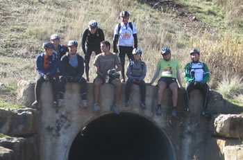 foto de grupo com os ciclistas sentados sobre a sada do tnel de Belas