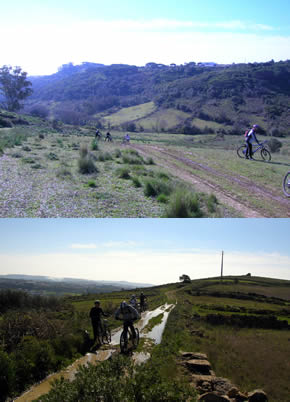 Vista sobre o vale com ciclistas a subirem o trilho e trilho com muita �gua